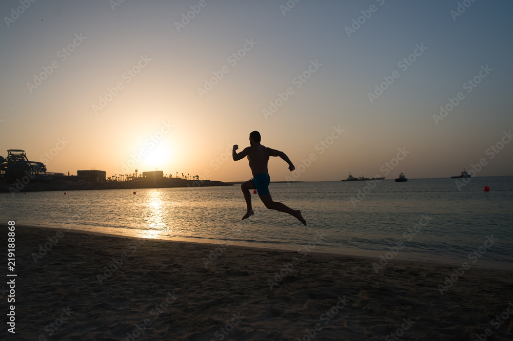 Silhouette man motion running in front of sunset sky above sea surface. Never stop. Future success depends on your efforts now. Daily motivation. Healthy lifestyle personal achievement and success