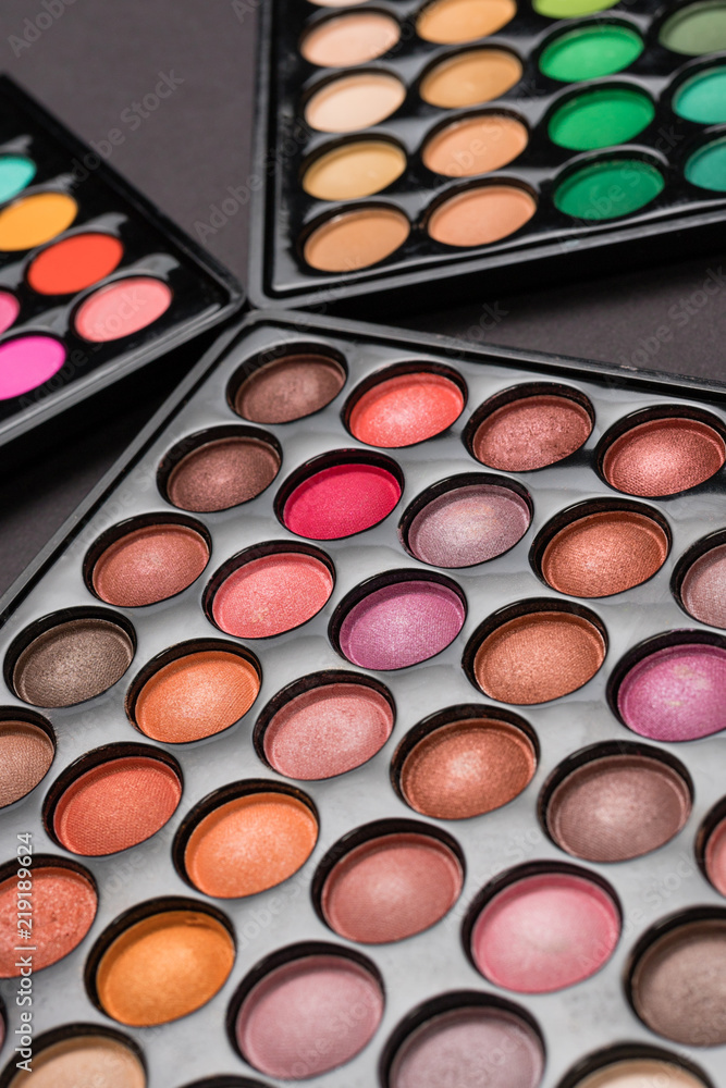 Close-up shot of eyeshadow palettes on black background Close-up shot of eyeshadow palettes on black background