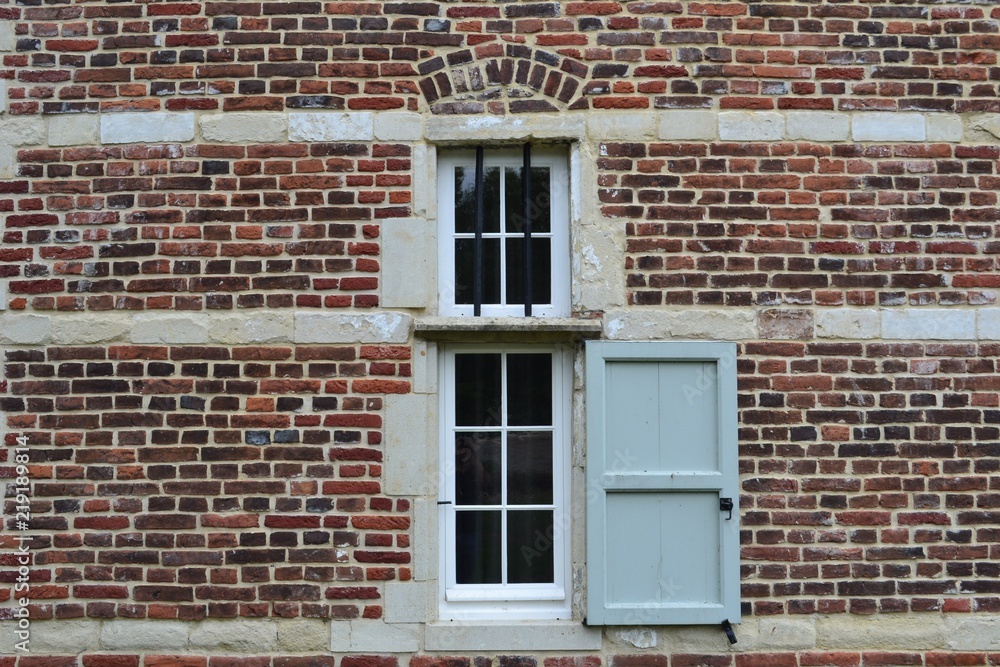 Closeup photograph of a window in a historical brick-and-limestone building. Taken at Park Abbey, Leuven, Belgium, Europe. Closeup photograph of a window in a historical brick-and-limestone building. Taken at Park Abbey, Leuven, Belgium, Europe.