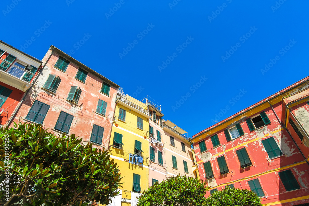 View on the beautiful colourful houses with clothes drying in the sunny daylight in Cique Terre, Italy. View on the beautiful colourful houses with clothes drying in the sunny daylight in Cique Terre, Italy.