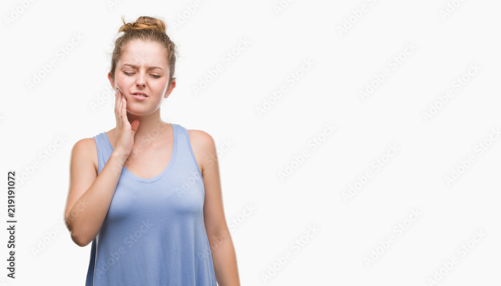 Young blonde woman touching mouth with hand with painful expression because of toothache or dental illness on teeth. Dentist concept. Young blonde woman touching mouth with hand with painful expression because of toothache or dental illness on teeth. Dentist concept.