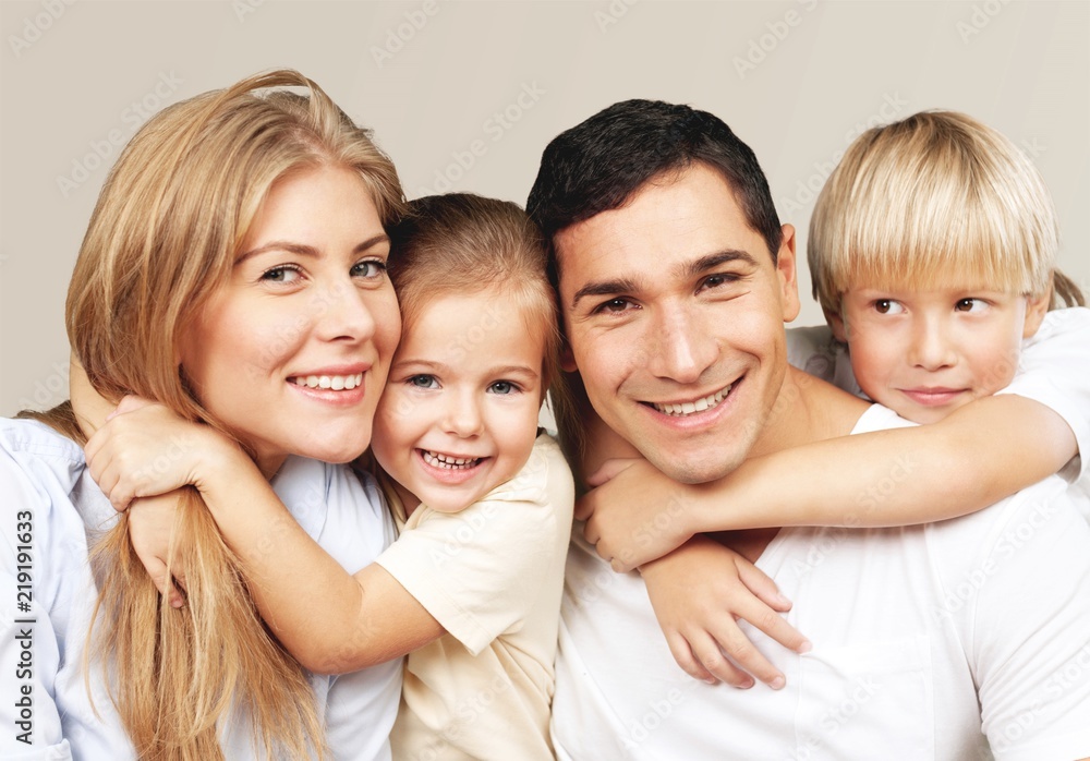 Beautiful smiling family sitting at sofa at home Beautiful smiling family sitting at sofa at home