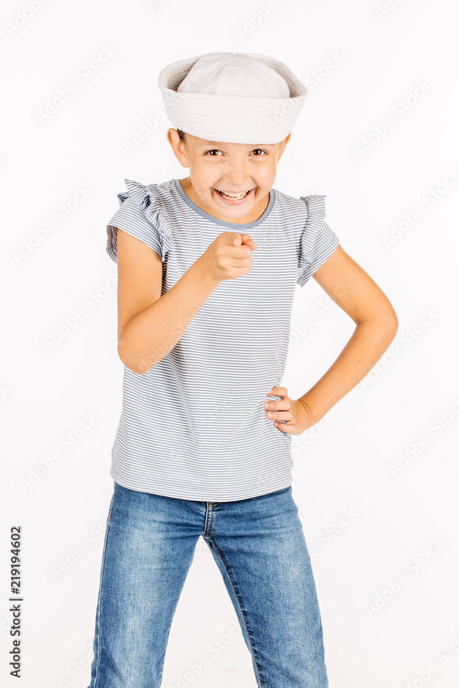 Little girl wearing a sailor costume and looking at the camera on white background. Little girl wearing a sailor costume and looking at the camera on white background.