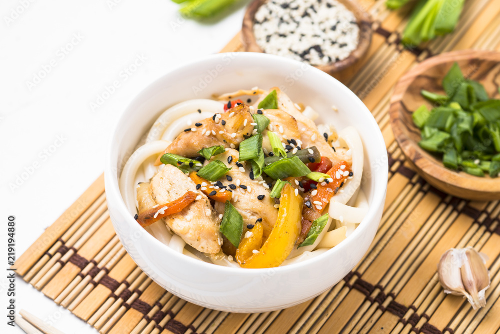 Udon stir-fry noodles with chicken and vegetables on white. Udon stir-fry noodles with chicken and vegetables on white.