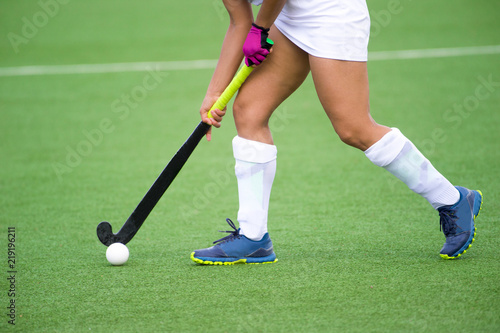 Young hockey player woman with ball in attack playing field hockey game © Augustas Cetkauskas