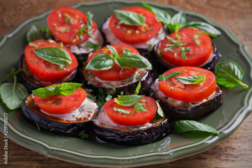 Aubergines with tomatoes and sauce. Pan fried eggplants. Healthy vegetarian food, appetizer. horizontal