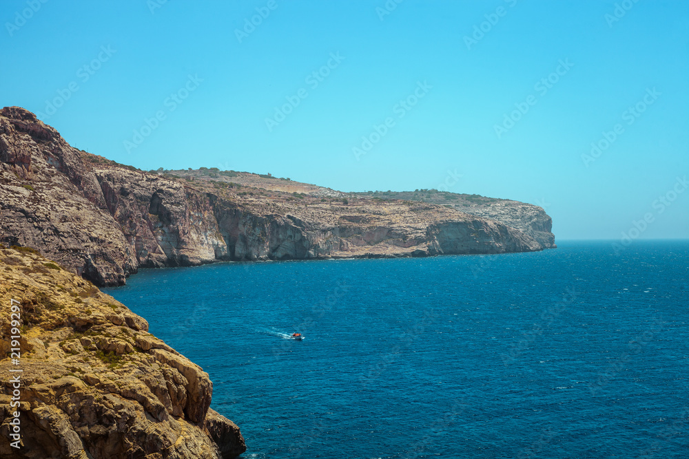 Rocky landscape, Ocean and boat in Malta