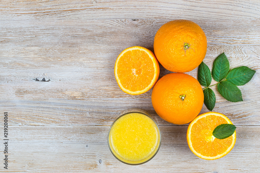 Orange juice and citrus fruits on rustic wooden table with copy space. top view. Orange juice and citrus fruits on rustic wooden table with copy space. top view.