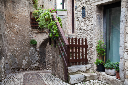 Photos Small town narrow street view with colorful houses in Malcesine