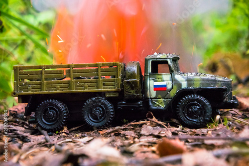 Burning of a russian military toy truck. Imitation of unexpected attack. photo