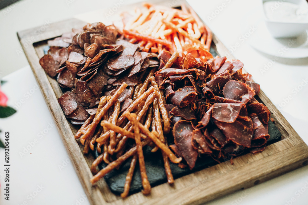 delicious table with different meat at wedding reception in restaurant. ham,salami,sausage and prosciutto on plate, luxury catering delicious table with different meat at wedding reception in restaurant. ham,salami,sausage and prosciutto on plate, luxury catering