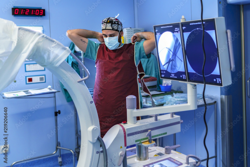 Radiology assistant preparing to take an x-ray inside the operating room