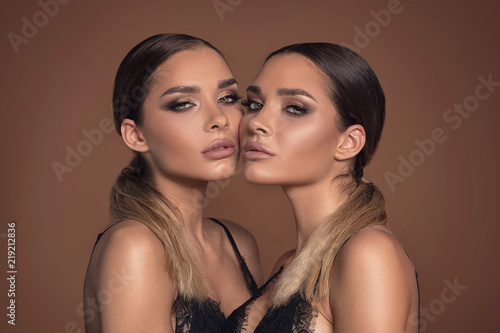 Portrait of two attractive women in glamour makeup.