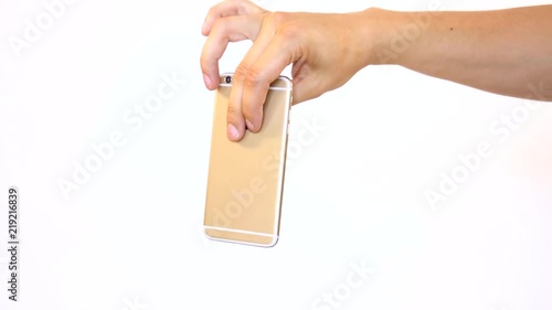 Dropping phone on purpose. Letting go of smartphone to drop to the ground and smash. Garbage old electronics thrown away to the floor by hand.