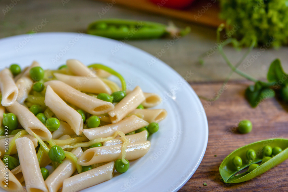 Penne pasta with green peas, zucchini noodle and herbs Penne pasta with green peas, zucchini noodle and herbs