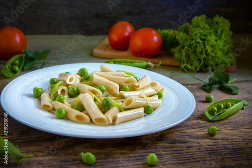 Penne pasta with green peas, zucchini noodle  and herbs