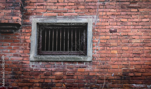 Security Bars On Old Window In Brick Wall.