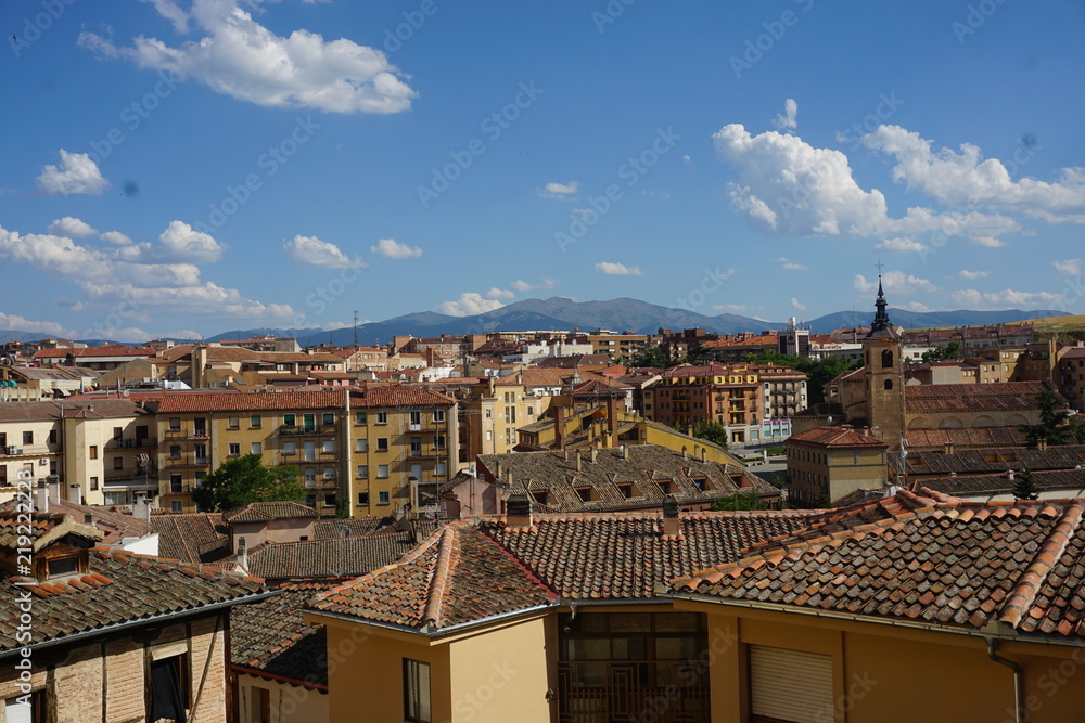 Spectacular view of Segovia, Spain from above the rooftop and blue sky with clouds.