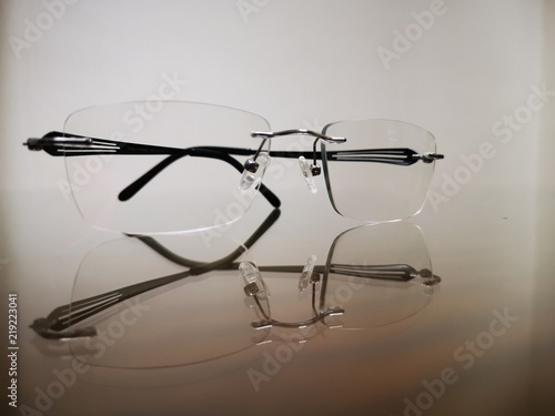 Close up eyeglasses and reflection on glass ground