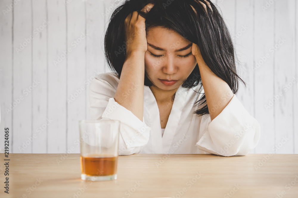depressed Asian woman drinking glass of alcohol depressed Asian woman drinking glass of alcohol