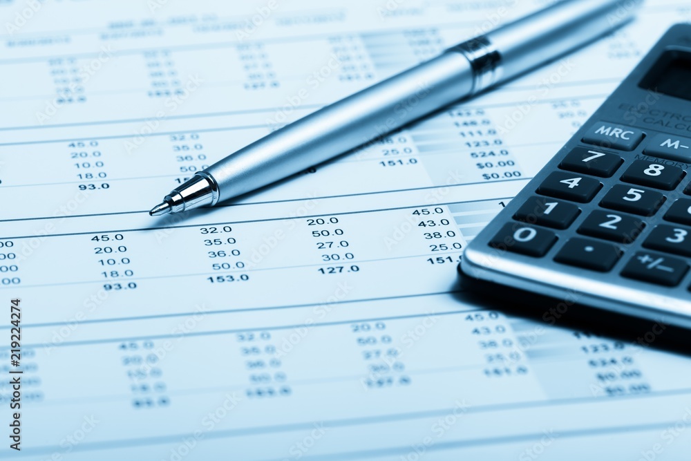 Pen and Calculator on Financial Figures Pen and Calculator on Financial Figures