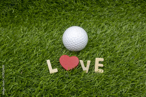 To golfer with love on Valentine's day with golf ball on green grass
