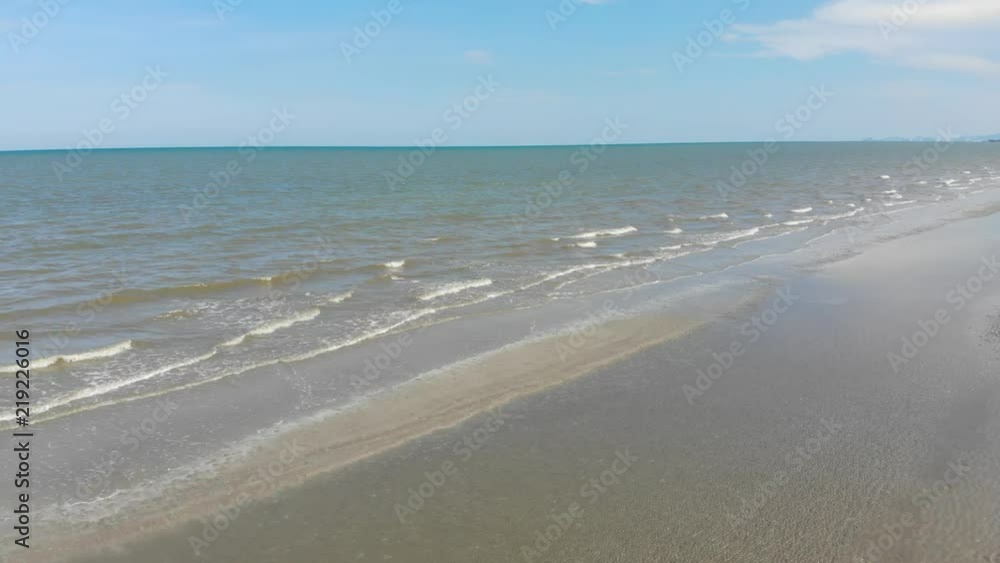 Aerial view Sea Beach and Soft wave Of Brown Ocean On Sandy Beach. Summer day with blue sky background Aerial view Sea Beach and Soft wave Of Brown Ocean On Sandy Beach. Summer day with blue sky background