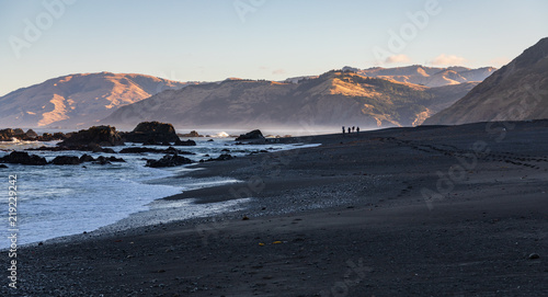Hikers on beach in the distance on California northern lost coast