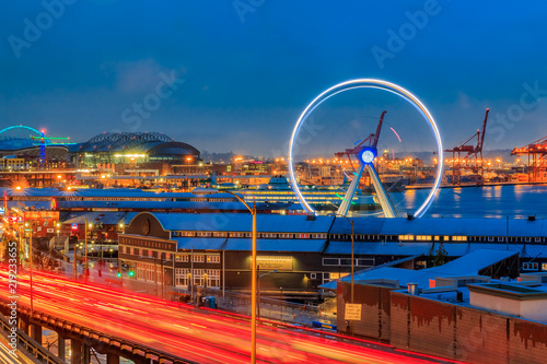 Seattle waterfront at sunset with Great Wheel and trail lights