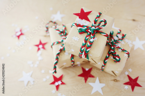 Christmas gifts in Kraft to packing on a wooden background