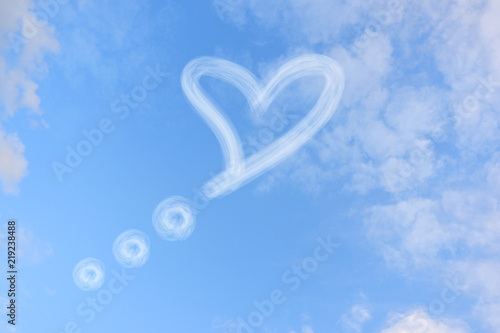 Heart-shaped bubbles speech on blue sky.