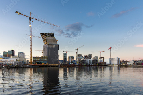 Modern buildings known as Barcode Project under construction in the center of Oslo at the sunset photo