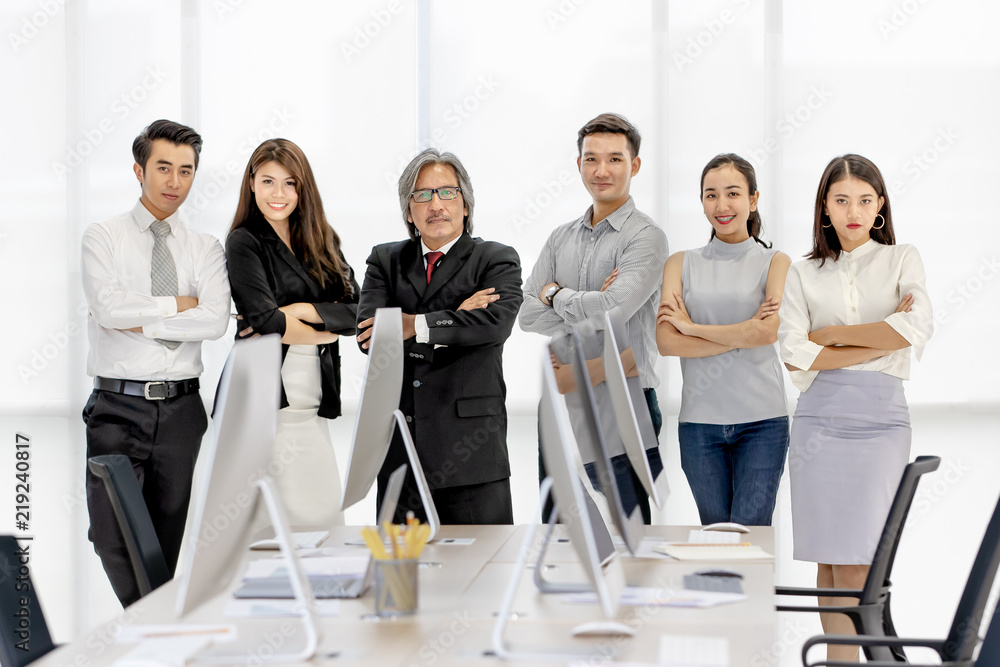 Group of 6 Asaina business people standing together in modern office, smiling and lookig fo camera