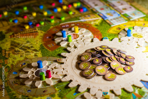 Colorful boardgame with cogwheels, figurines, chips and playing cards