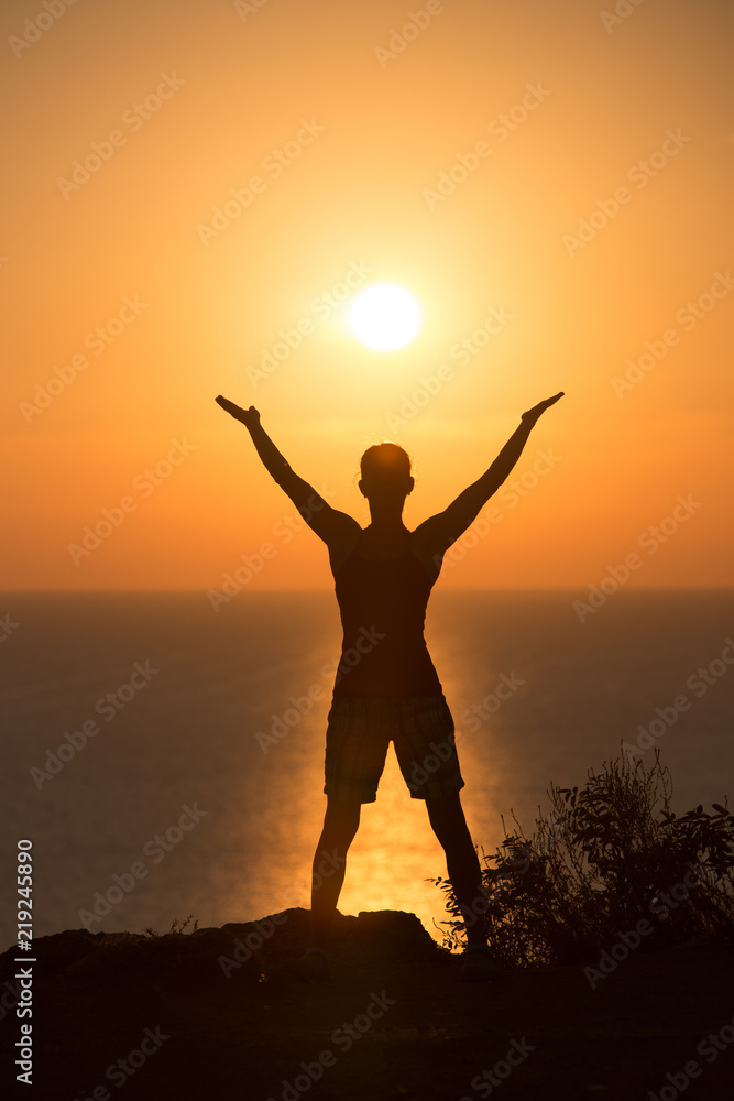 silhouette of a woman doing yoga during the sunset 