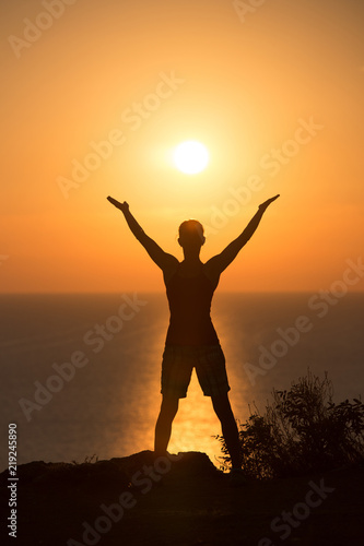 silhouette of a woman doing yoga during the sunset 