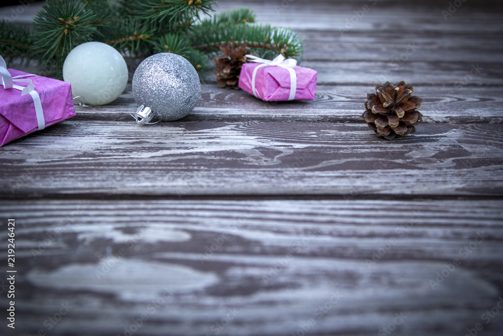 Christmas holiday background with gifts boxes with fir branches, pine cones, christmas balls on wooden table. Christmas holiday background with gifts boxes with fir branches, pine cones, christmas balls on wooden table.