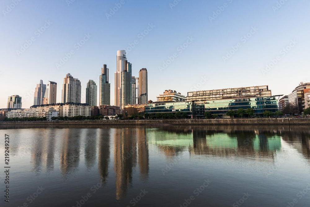 Skyscrapers in Puerto Madero business district in Buenos Aires against colorful blue sky 