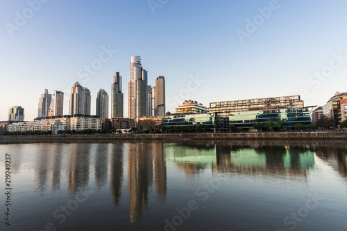 Skyscrapers in Puerto Madero business district in Buenos Aires against colorful blue sky 