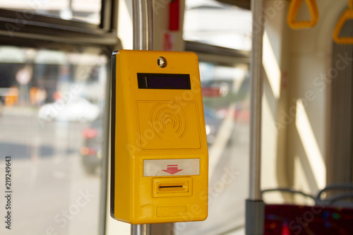 Yellow device to punch travel tickets in municipal transport. Punching device for payment of travel in city municipal transport. Payment for travel in the municipal trolleybus, bus, tram.