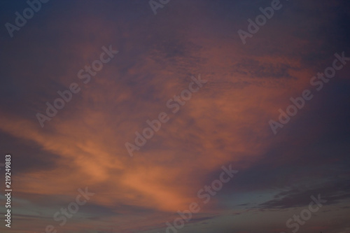 View on beautiful pink clouds in a pink blue sky. © beldesigne