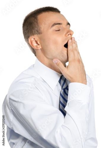 Tired Young Businessman Yawning and Covering his Mouth -