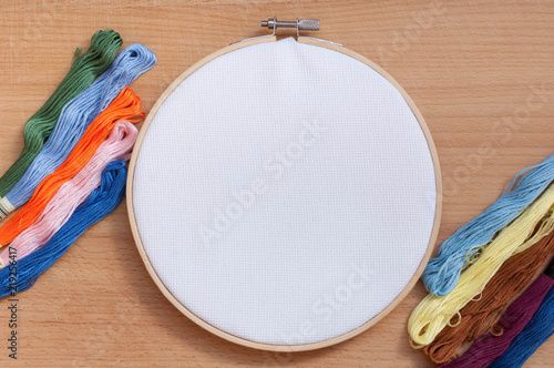 Round wooden hoop with a white cloth.