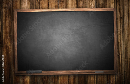 Blackboard on rustic wooden wall