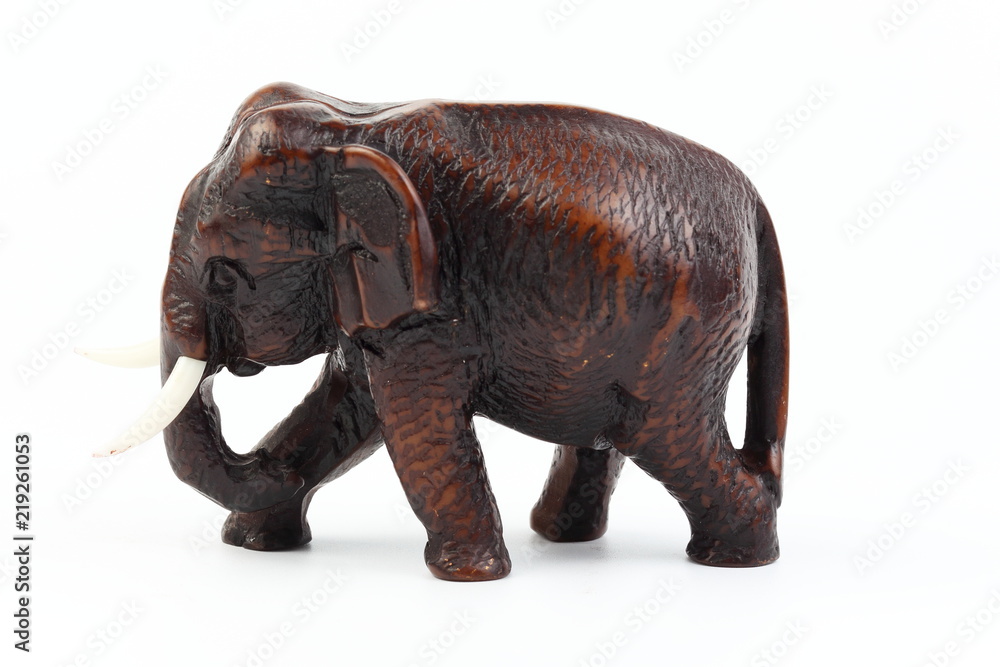 Fototapeta premium Brown elephant made of resin like wood carving with candle holder with white ivory. Stand on white background, Isolated, Art Model Thai Crafts, For decoration Like in the spa.