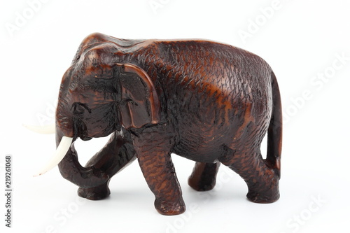 Brown elephant made of resin like wood carving with candle holder with white ivory. Stand on white background  Isolated  Art Model Thai Crafts  For decoration Like in the spa.