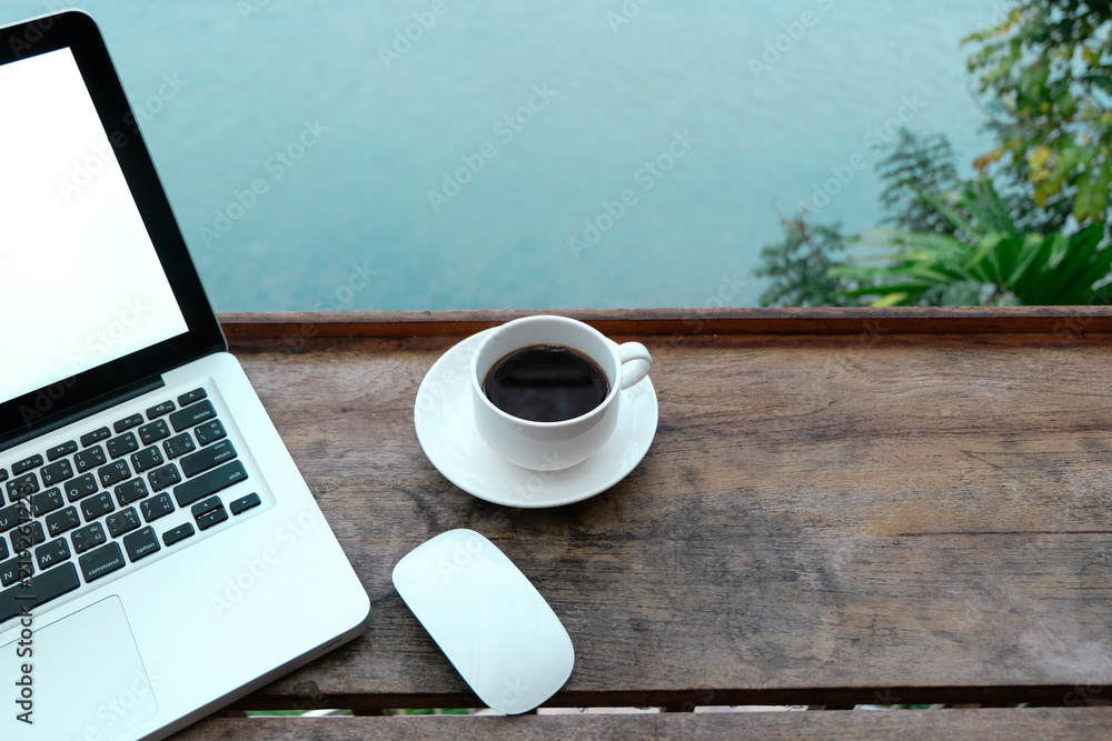 Mockup image of laptop with blank white screen on wooden table in terrace nearby river. Mockup image of laptop with blank white screen on wooden table in terrace nearby river.