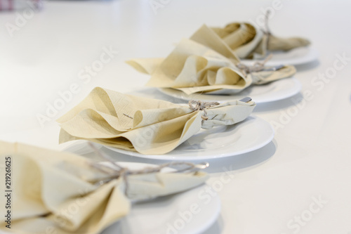 table setting with white plate and a napkin