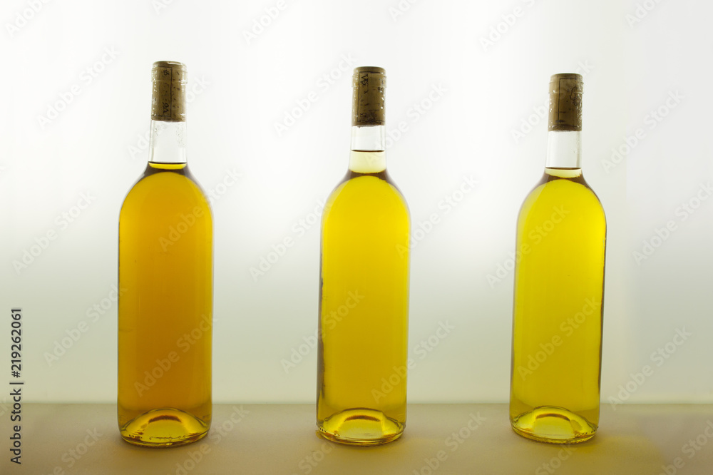 Three bottles of white wine with different tones