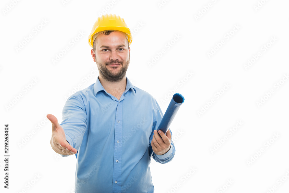 Young architect holding blueprints and offering handshake gesture Young architect holding blueprints and offering handshake gesture